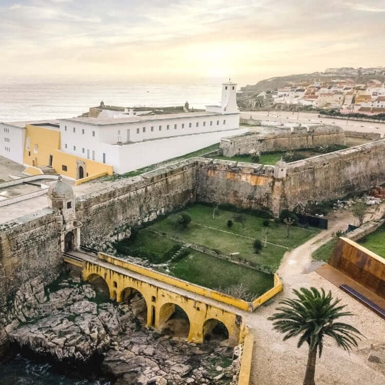 Historic fortification with walls and gardens overlooking the sea.