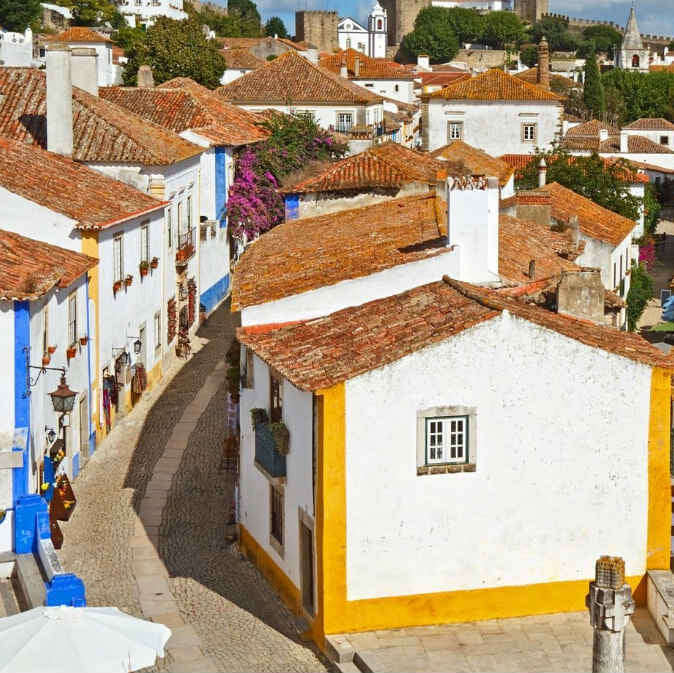 Traditional Portuguese village with white houses and red-tiled roofs.